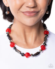 Load image into Gallery viewer, Necklace with red and black beads worn by a model on a white background